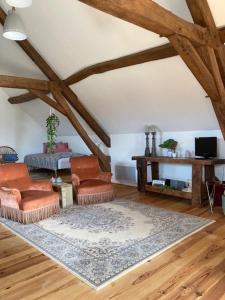 a living room with two chairs and a couch at chambres d'hôtes Domaine les Grands Pérons in Hérisson