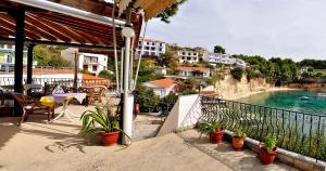 a balcony with a table and a view of a river at Pension Dimitris in Votsi
