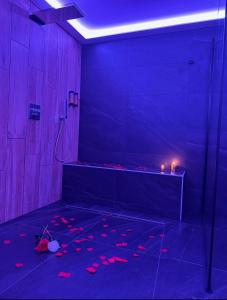 a dark room with a shower with red lights at Loveroom Metz Spa Privatif in Metz