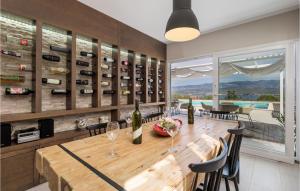 a dining room with a table with wine bottles at Awesome Home In Polje With House Sea View in Polje