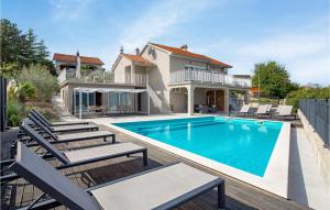 a swimming pool with chairs and a house at Awesome Home In Polje With House Sea View in Polje