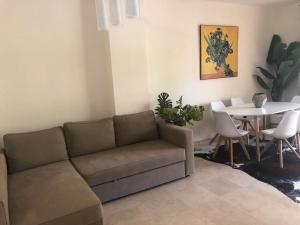 un soggiorno con divano e tavolo di Apartamento en primera línea de playa a Marbella