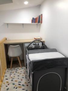 a bedroom with a bed and a desk and a chair at Duplex neuf, 15mn de Paris, parking, climatisation in Bourg-la-Reine
