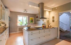 a large kitchen with a sink and a counter at Stunning Home In Gteborg With Sauna in Gothenburg