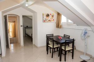 a dining room with a table and chairs at Attic flat ''Tsoukalas Group'' in Zakynthos