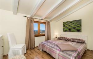 um quarto com uma cama e uma janela em Nice Home In Palit With Wifi em Mundanije