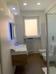 baño con lavabo y aseo y ventana en Agasweethome Rome Gemelli en Roma