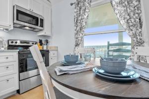 a kitchen with a table with blue bowls on it at Appian Way Maltese Cottage in Fredericksburg