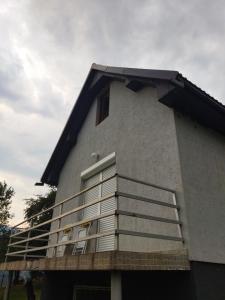 a building with a balcony on the side of it at Country house Eco estate in Bijelo Polje