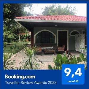 a small house with a patio and a sign that says travel review awards at Gray Beach House in Potrero