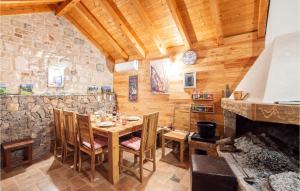 a dining room with a table and a fireplace at Lovely Home In Lovrec With Kitchen in Lovreć