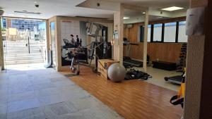 a gym with a treadmill and a exercise bike in a room at Haus Flat particular em Brasilia in Brasilia