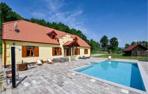 a house with a swimming pool in front of it at Stunning Home In Konjscina With House A Panoramic View in Husinec