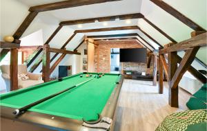 a pool table in a living room with wooden beams at Stunning Home In Konjscina With House A Panoramic View in Husinec
