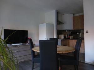 a kitchen with a table and chairs in a room at T2 50m2 résidence les Acacias Vue Dégagée Montagne in Ax-les-Thermes