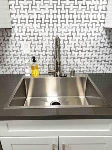 a stainless steel sink in a kitchen at Luxury condo in the heart of Midtown Sacramento in Sacramento