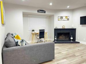 a living room with a couch and a fireplace at Luxury condo in the heart of Midtown Sacramento in Sacramento