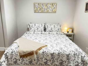 a bedroom with a bed with a white and black comforter at Luxury condo in the heart of Midtown Sacramento in Sacramento