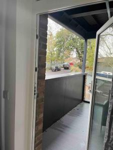 an open door to a garage with a view of a driveway at Lovely one bedroom apartment with balcony in Forest Hill