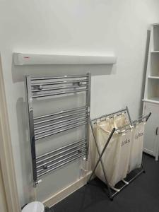 a metal cart in a room with a shelf at Lovely one bedroom apartment with balcony in Forest Hill