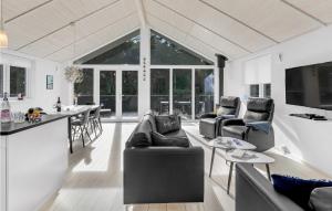 a kitchen and living room with couches and a table at Stunning Home In Nex With Sauna in Neksø
