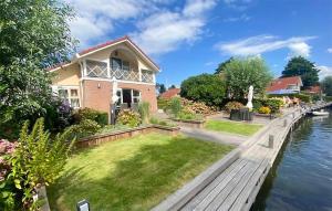 a house on the water next to a canal at 3 Bedroom Lovely Home In Workum in Workum