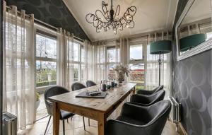 a dining room with a table and chairs and a chandelier at 3 Bedroom Lovely Home In Workum in Workum