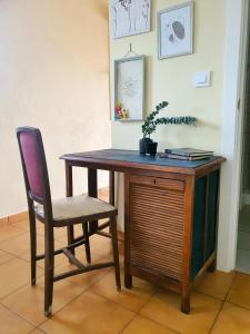 a wooden table with a chair and a desk at Apartamento Rural El Ciprés Complejo la Fontanina in Mata de Alcántara