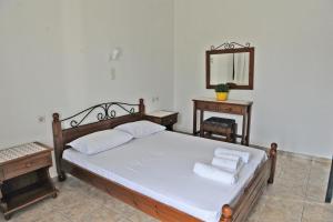 A bed or beds in a room at Morfeas Hotel