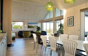 a dining room with a table and chairs at Gorgeous Home In Ringkøbing With Sauna in Ringkøbing