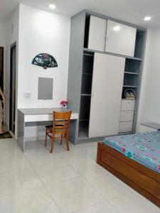 a bedroom with a desk and a bed and a chair at A&H apartment, new, close to beach and market, in quite peaceful street in Nha Trang