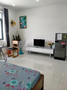 a living room with a tv and a couch at A&H apartment, new, close to beach and market, in quite peaceful street in Nha Trang