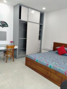 a bedroom with a bed and a desk at A&H apartment, new, close to beach and market, in quite peaceful street in Nha Trang