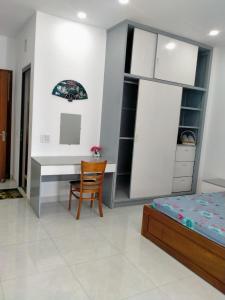 a bedroom with a desk and a bed at A&H apartment, new, close to beach and market, in quite peaceful street in Nha Trang
