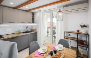 a kitchen and dining room with a table and chairs at Stunning Apartment In Vabriga With Wifi in Vabriga