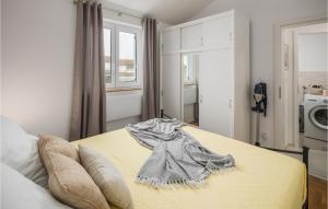 a bedroom with a bed with a towel on it at Stunning Apartment In Vabriga With Wifi in Vabriga +16 photos