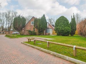 a house with a brick driveway and a bench at Forest Close in Forest Hall