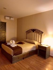 Postel nebo postele na pokoji v ubytování HOTEL PLAZA PACHUCA