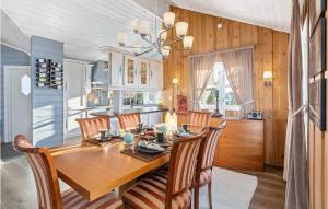 a kitchen and dining room with a wooden table and chairs at Gorgeous Home In yer With Sauna in Øyer