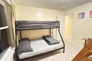 a bedroom with two bunk beds in a room at Modern 5 Bedroom Pocono house - Jacuzzi - Gameroom - Near Lake - Golf Couse in Tobyhanna