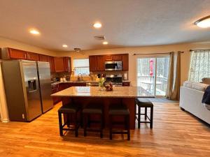 a kitchen with a large island in the middle of a room at Modern 5 Bedroom Pocono house - Jacuzzi - Gameroom - Near Lake - Golf Couse in Tobyhanna