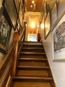a staircase in a building with paintings on the wall at Charming 2 bedroom flat in Canterbury