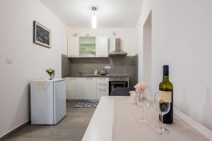 a bottle of wine sitting on a table in a kitchen at Bozena's studio apartment in Split +16 photos