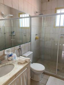 y baño con ducha, aseo y lavamanos. en Casa Caiçara no Caborê, en Paraty