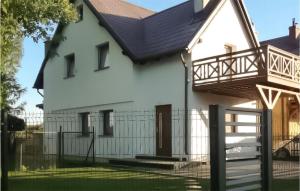 a white house with a balcony on top of it at Beautiful Home In Koscierzyna With Wifi in Kościerzyna