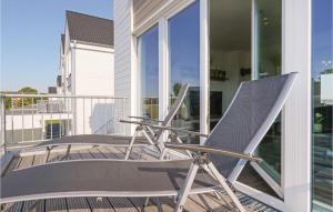 a pair of chairs sitting on a balcony at Haus Musica in Olpenitz +29 photos