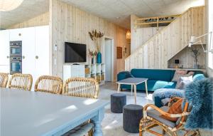 a living room with a blue couch and chairs at Beautiful Home In Nex With Wifi in Snogebæk