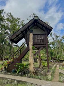 a tree house in the middle of a park at ROCA'S HOMESTAY Backpackers Chalet Bohol in Batuan