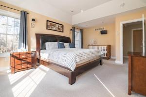 a bedroom with a large bed and a television at Luxury 4 bedroom house in Pocono Mountains in Golf course Near Lake in Tobyhanna