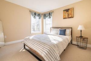 a bedroom with a large bed and a window at Luxury 4 bedroom house in Pocono Mountains in Golf course Near Lake in Tobyhanna